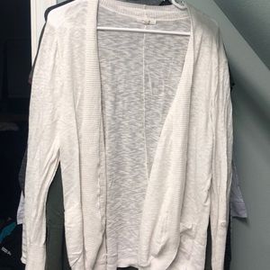 Cream colored long sleeved cardigan with pockets